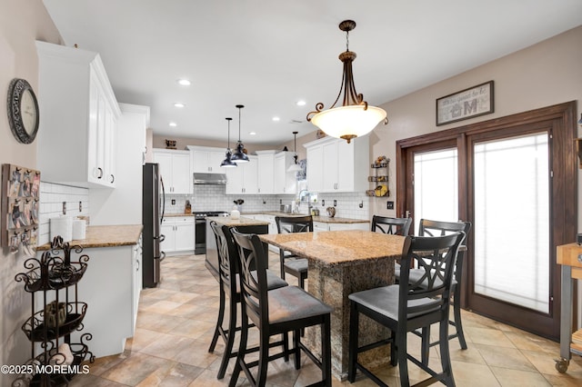 dining room with recessed lighting and light tile patterned flooring