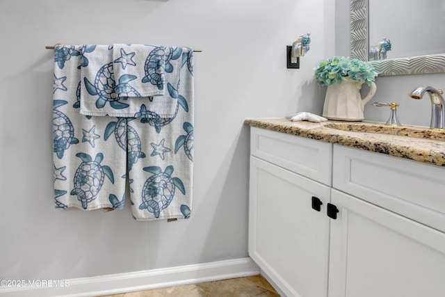 bathroom featuring baseboards, vanity, and tile patterned flooring