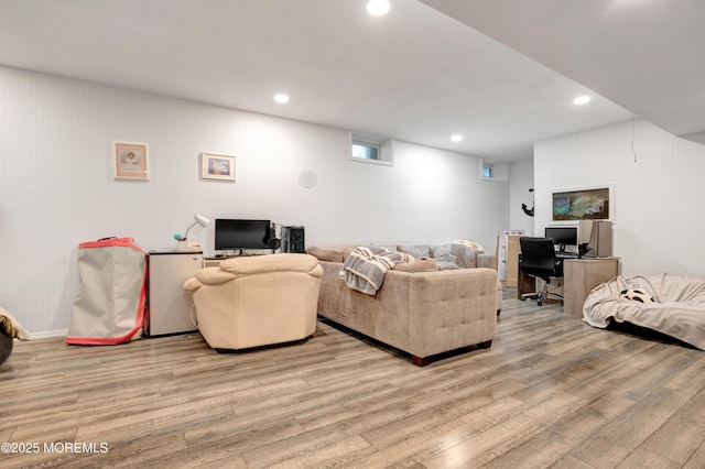 living room featuring light wood-style flooring, a desk, and recessed lighting