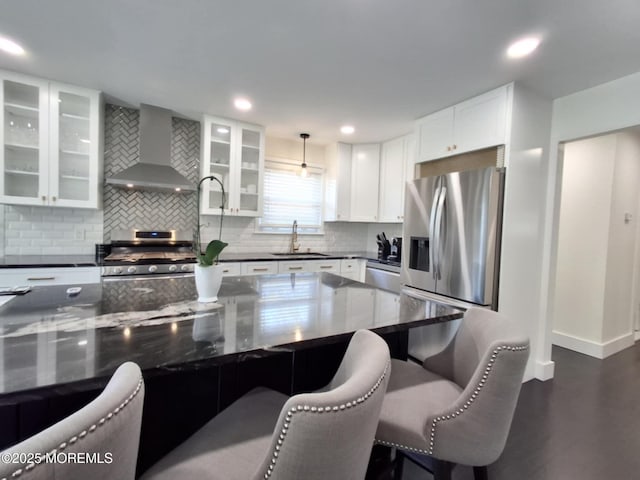 22 Macedulski Ter, South Amboy, NJ 08879 - kitchen with wall chimney exhaust hood, stainless steel appliances, tasteful backsplash, white cabinetry, and a kitchen breakfast bar