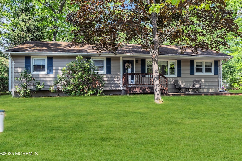 single story home with a porch and a front yard