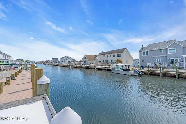 dock area with a residential view and a water view