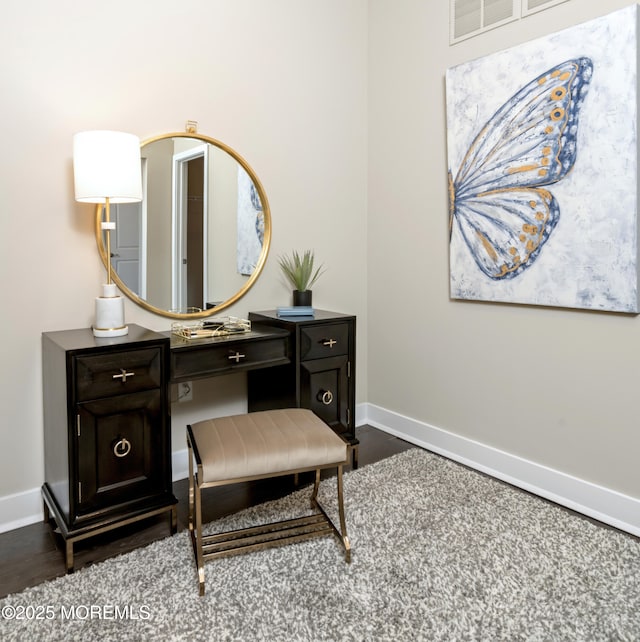 bathroom with baseboards and wood finished floors