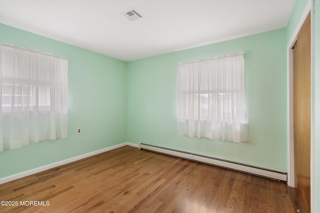 23 Marathon St, Toms River, NJ 08757 - spare room featuring a baseboard heating unit, wood finished floors, and baseboards