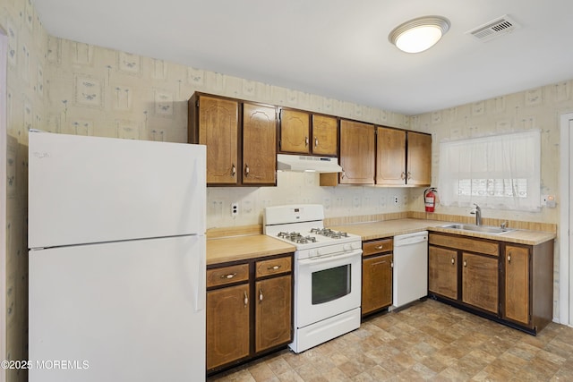 23 Marathon St, Toms River, NJ 08757 - kitchen with white appliances, under cabinet range hood, a sink, wallpapered walls, and light countertops