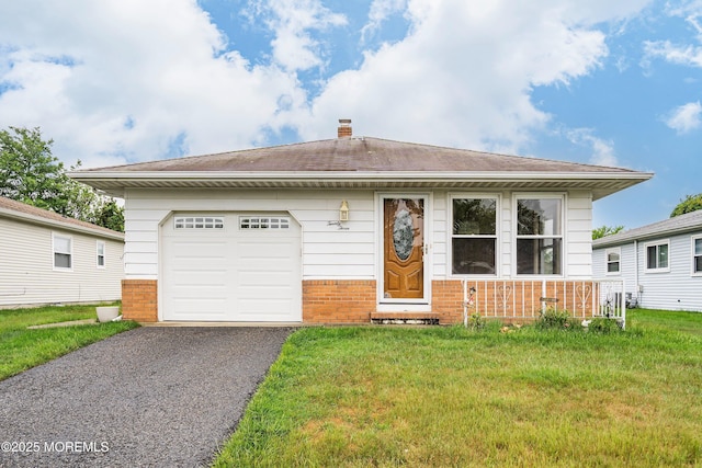23 Marathon St, Toms River, NJ 08757 - view of front of property with brick siding, a front lawn, driveway, and a chimney