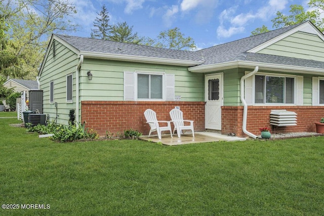 40 Mallard St Unit B, Manchester, NJ 08759 - rear view of house featuring brick siding, a shingled roof, and a lawn