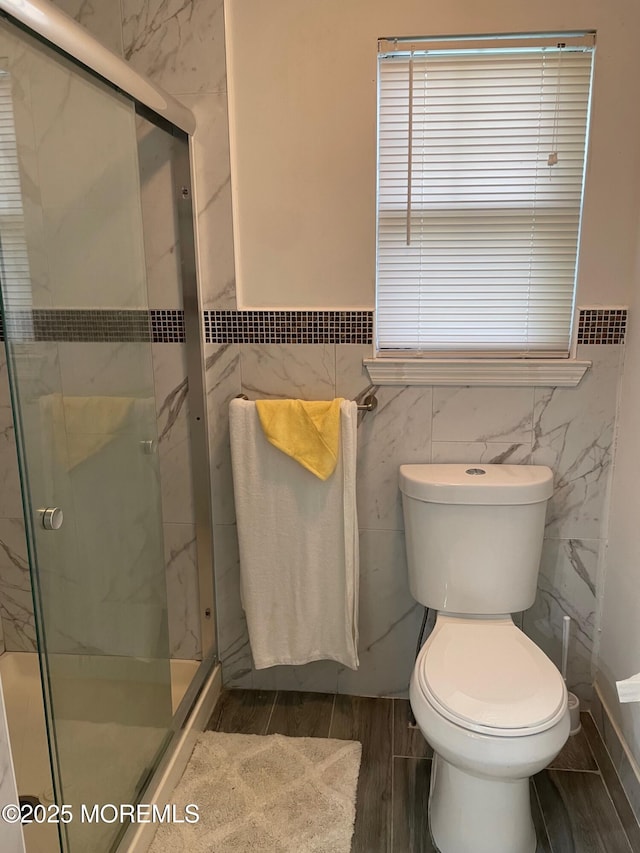 518 Petunia Ln N, Whiting, NJ 08759 - bathroom with tile walls, wood finished floors, a marble finish shower, toilet, and plenty of natural light