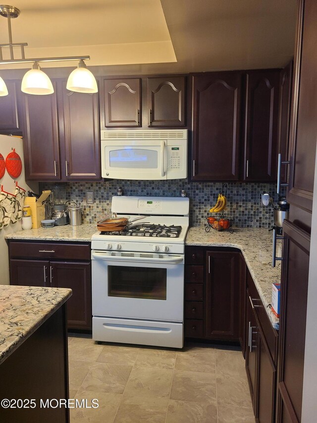 1207A Thornbury Ln Unit A, Manchester, NJ 08759 - kitchen featuring white appliances, tasteful backsplash, light stone counters, and dark brown cabinetry