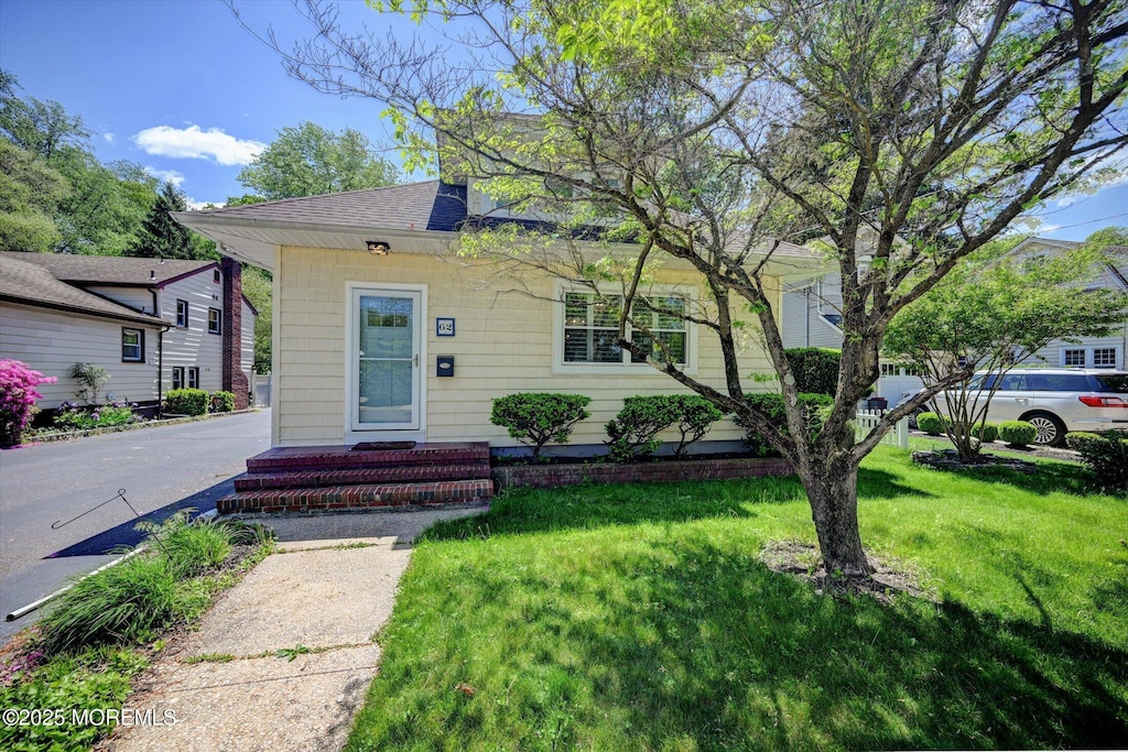 62 Madison Ave, Red Bank, NJ 07701 - view of front facade featuring a front lawn and a shingled roof