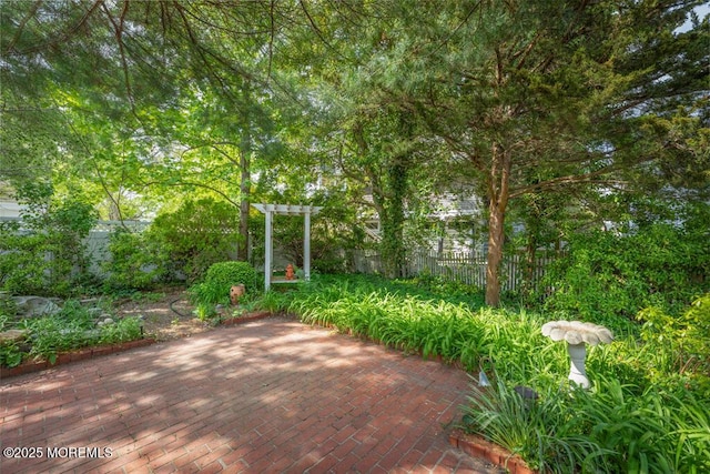 view of patio / terrace with a pergola and fence