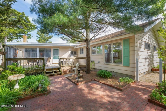 back of house featuring a deck and a patio area