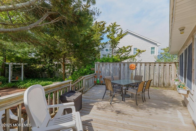 wooden deck featuring outdoor dining area and fence