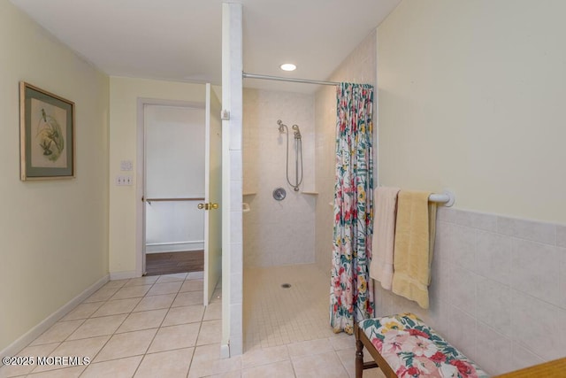 bathroom with a tile shower, tile patterned floors, and recessed lighting