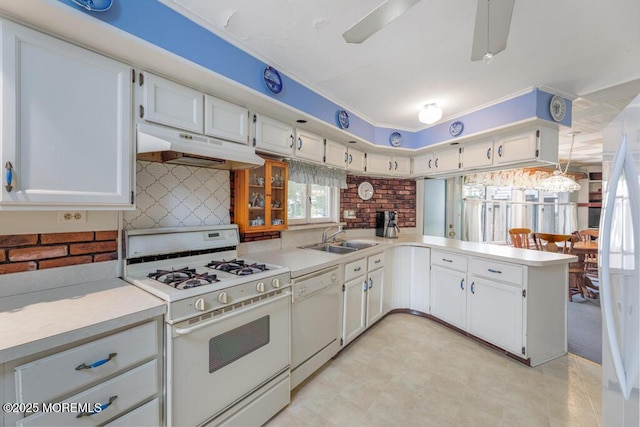kitchen with white appliances, under cabinet range hood, a sink, light countertops, and white cabinetry