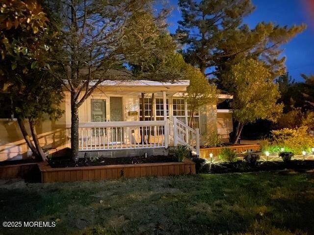 back of property with a yard