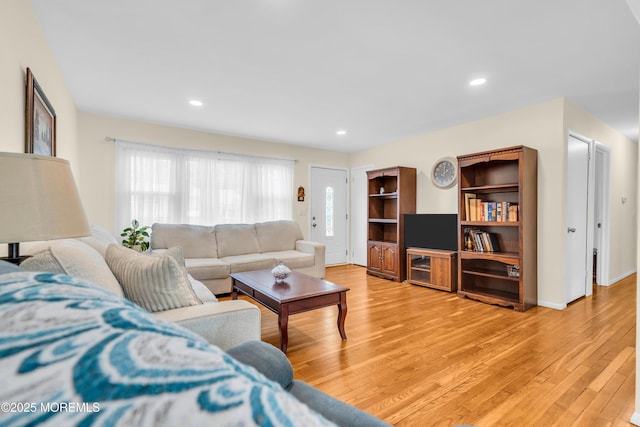 living room featuring light wood-type flooring and recessed lighting