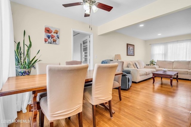 dining room featuring ceiling fan, light wood-style flooring, recessed lighting, and beam ceiling