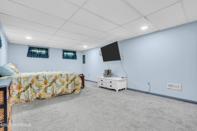 carpeted bedroom featuring recessed lighting and a paneled ceiling