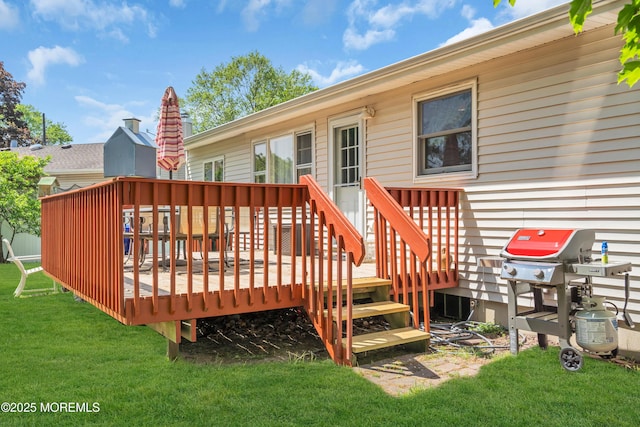deck featuring a lawn and a grill