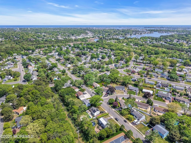 aerial view of property and surrounding area featuring nearby suburban area