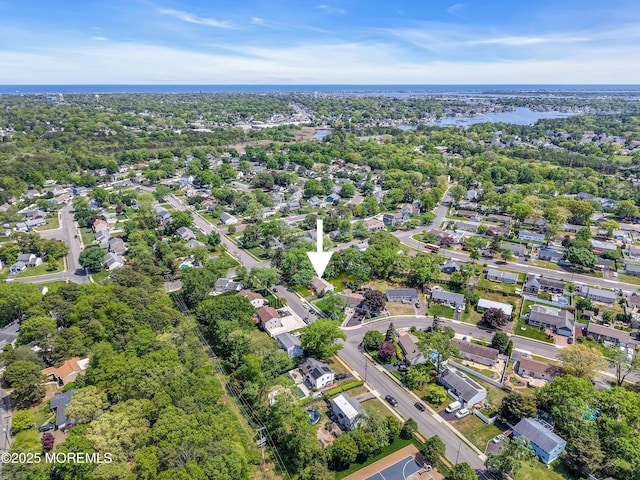 aerial view of property and surrounding area featuring nearby suburban area