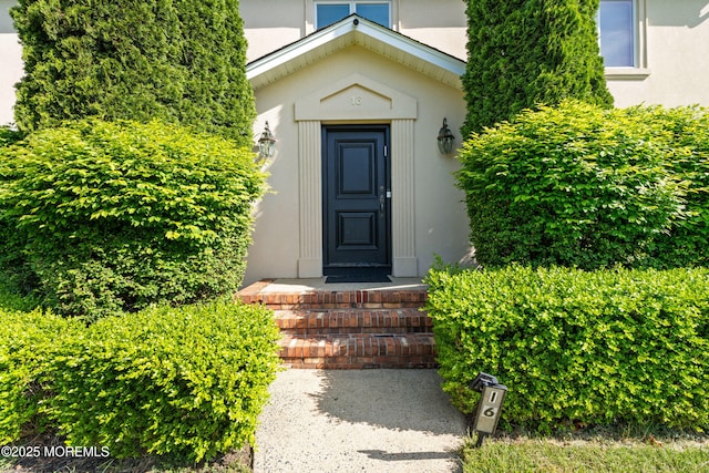 16 Bridle Dr, West Long Branch, NJ 07764 - view of exterior entry with stucco siding