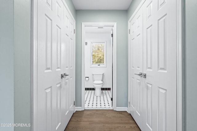 16 Bridle Dr, West Long Branch, NJ 07764 - doorway with baseboards and dark wood-type flooring