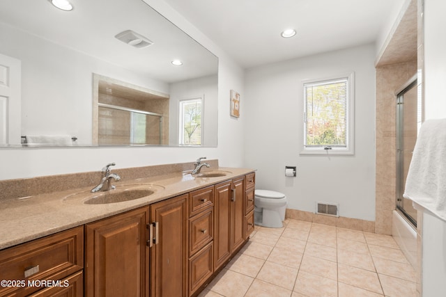 16 Bridle Dr, West Long Branch, NJ 07764 - full bath with double vanity, toilet, tile patterned floors, recessed lighting, and combined bath / shower with glass door