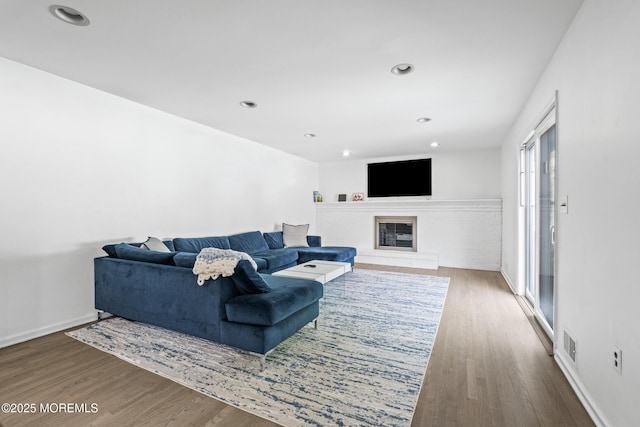 16 Bridle Dr, West Long Branch, NJ 07764 - living area with wood finished floors, a glass covered fireplace, baseboards, and recessed lighting
