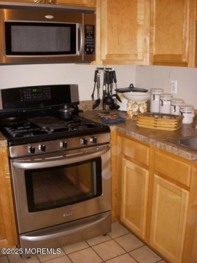 1108 Lilly Ln, Jackson, NJ 08527 - kitchen with stainless steel appliances, light tile patterned flooring, and light brown cabinets