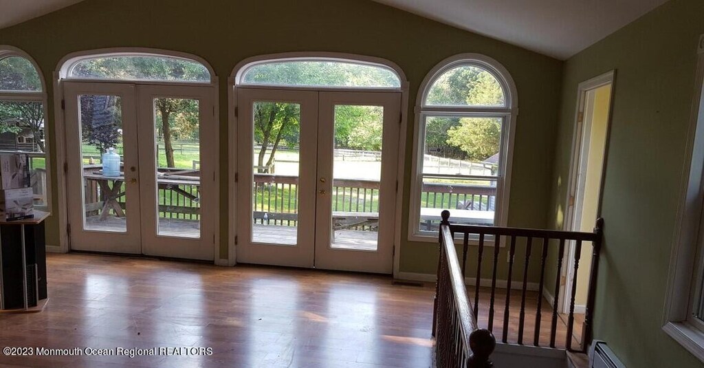 360 W Veterans Hwy, Jackson, NJ 08527 - entryway with french doors, lofted ceiling, wood finished floors, and a baseboard heating unit