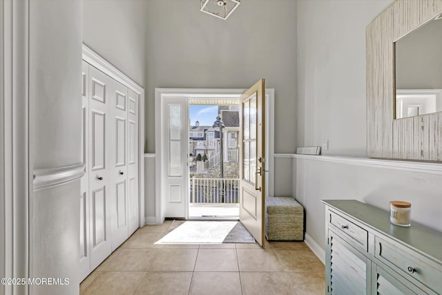 6 Tower Rd, Long Branch, NJ 07740 - doorway to outside with light tile patterned floors, baseboards, and a towering ceiling