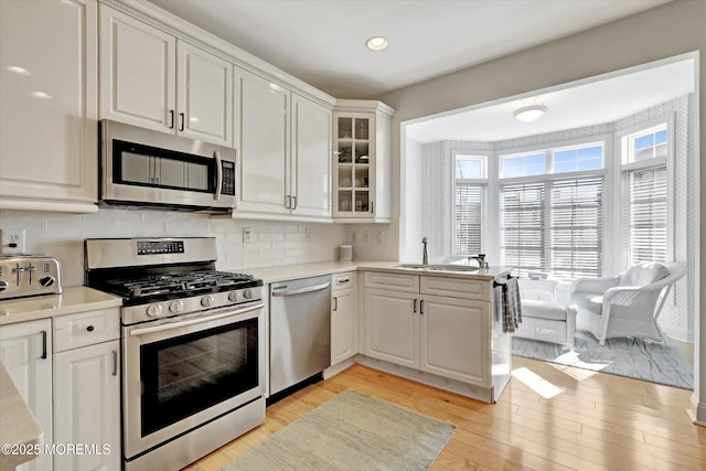 6 Tower Rd, Long Branch, NJ 07740 - kitchen with appliances with stainless steel finishes, a sink, light wood-style flooring, white cabinets, and recessed lighting