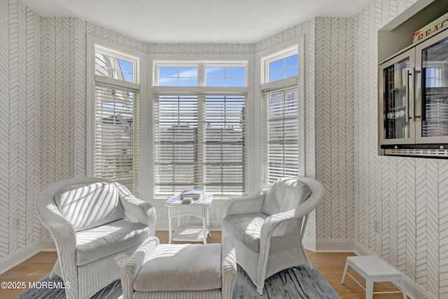 6 Tower Rd, Long Branch, NJ 07740 - living area featuring wallpapered walls, plenty of natural light, wood finished floors, and baseboards
