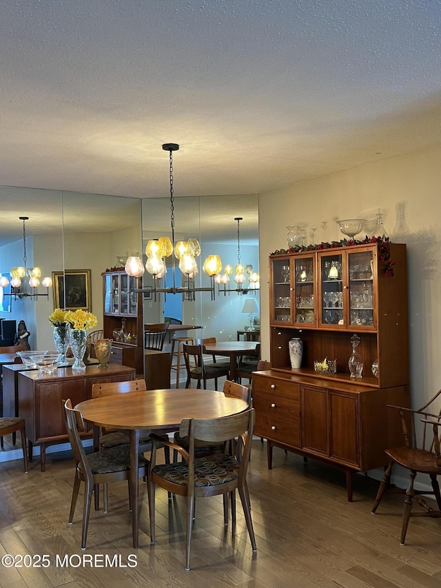 1 Channel Dr Unit 1203, Monmouth Beach, NJ 07750 - dining area featuring a chandelier and wood finished floors