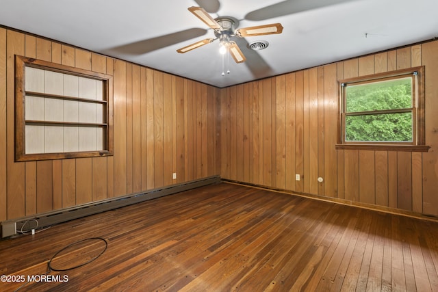205 Edgemere Dr, Toms River, NJ 08755 - empty room with baseboard heating, dark wood-style floors, wood walls, and a ceiling fan