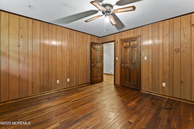 205 Edgemere Dr, Toms River, NJ 08755 - unfurnished bedroom featuring wood-type flooring, wooden walls, and a ceiling fan