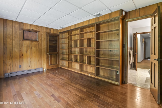 205 Edgemere Dr, Toms River, NJ 08755 - unfurnished room featuring a baseboard heating unit, wood walls, and wood finished floors