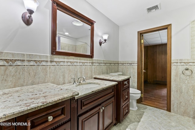 205 Edgemere Dr, Toms River, NJ 08755 - full bathroom featuring tile walls, a wainscoted wall, toilet, vanity, and tile patterned flooring