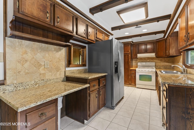 205 Edgemere Dr, Toms River, NJ 08755 - kitchen featuring white gas stove, stainless steel refrigerator with ice dispenser, a sink, under cabinet range hood, and backsplash