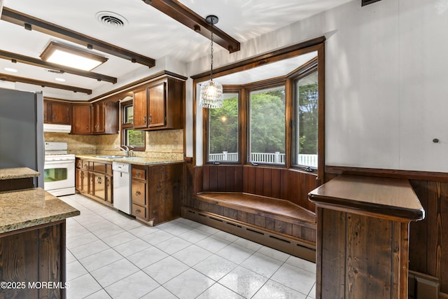205 Edgemere Dr, Toms River, NJ 08755 - kitchen with white appliances, under cabinet range hood, backsplash, hanging light fixtures, and a sink