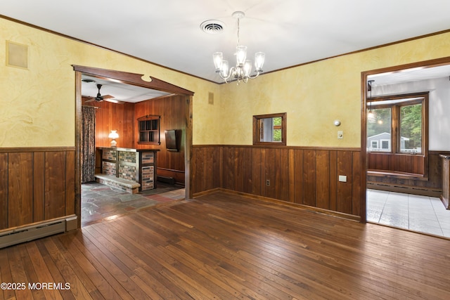 205 Edgemere Dr, Toms River, NJ 08755 - unfurnished dining area with wainscoting, wood-type flooring, wooden walls, a chandelier, and a ceiling fan
