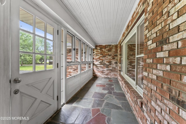 205 Edgemere Dr, Toms River, NJ 08755 - unfurnished sunroom featuring brick wall and stone finish flooring