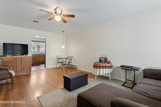 80 Falmouth Ave Unit 72, Whiting, NJ 08759 - living room featuring a ceiling fan, light wood finished floors, and baseboards