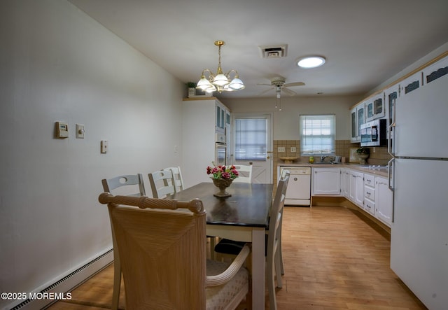 30F Cambridge Ct, Lakewood, NJ 08701 - dining room featuring a baseboard radiator, a ceiling fan, and light wood finished floors