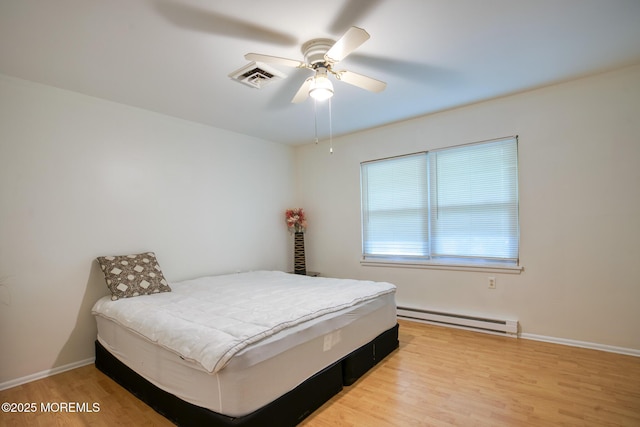 30F Cambridge Ct, Lakewood, NJ 08701 - bedroom with a baseboard radiator, wood finished floors, ceiling fan, and baseboards