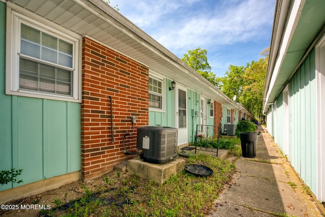 30F Cambridge Ct, Lakewood, NJ 08701 - view of property exterior with central air condition unit, brick siding, and board and batten siding