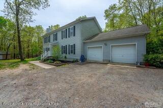 colonial inspired home featuring driveway and a garage