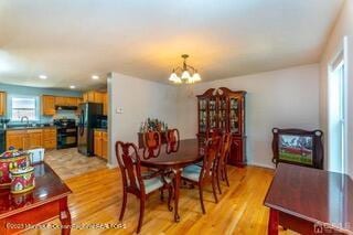 dining room featuring a chandelier, light wood-style floors, and recessed lighting